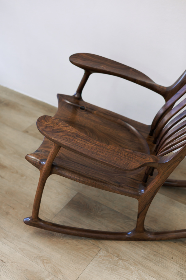 Modern handcrafted wooden rocking chair with smooth curves
